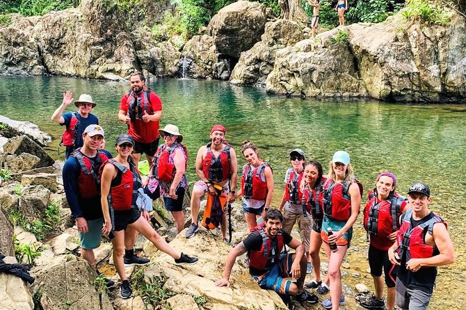 Half-Day: Rainforest and Waterslide Adventure with Transportation - A forest walk with mud, rocks, and river crossings